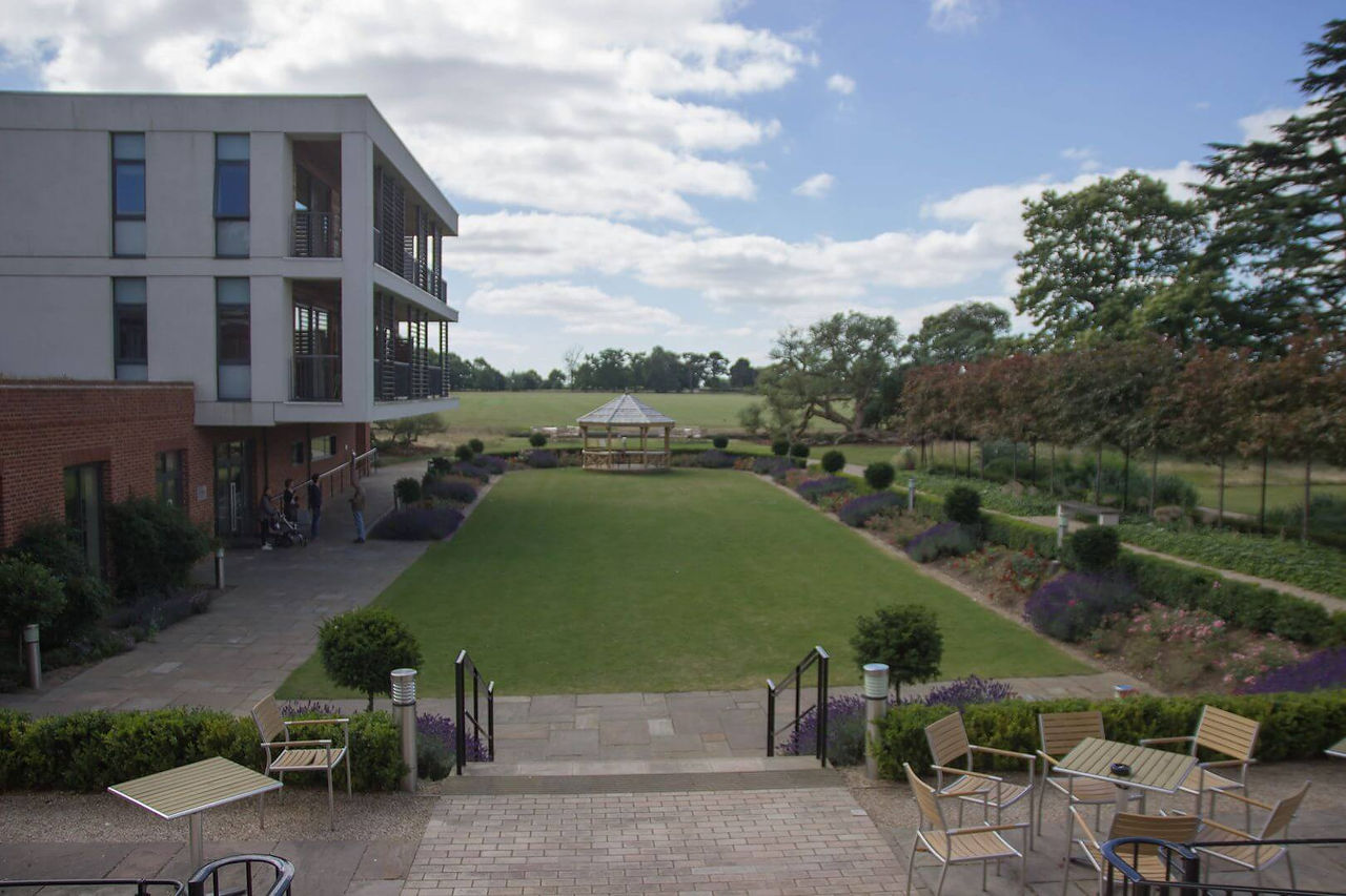 View across the sunken lawn at Wivenhoe House Hotel towards the gazebo and fields beyond