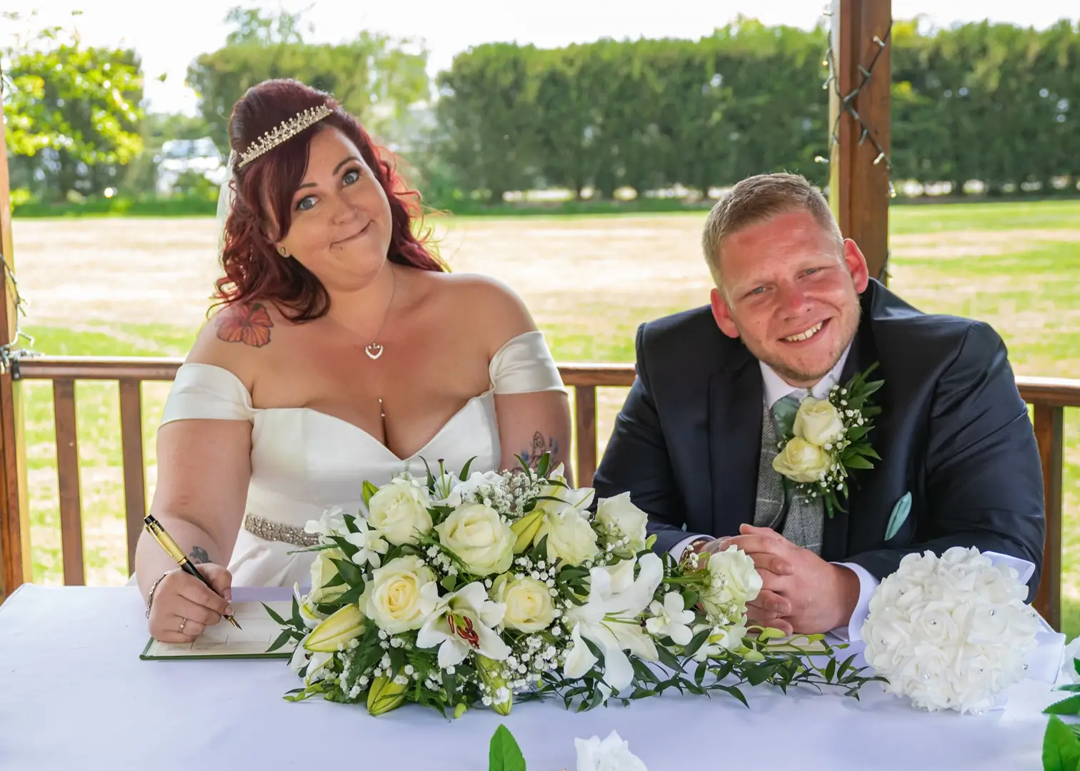 Bride pulls a funny face at her outdoor Essex wedding ceremony