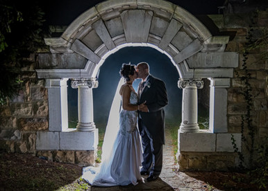 Bride and groom backlit at night at Ye Olde Plough House