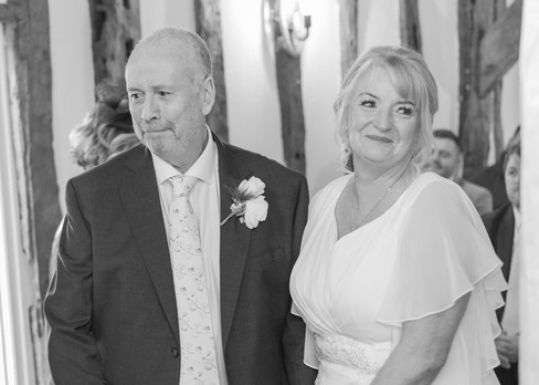 Bride and groom smile during their wedding vows at Little Channels