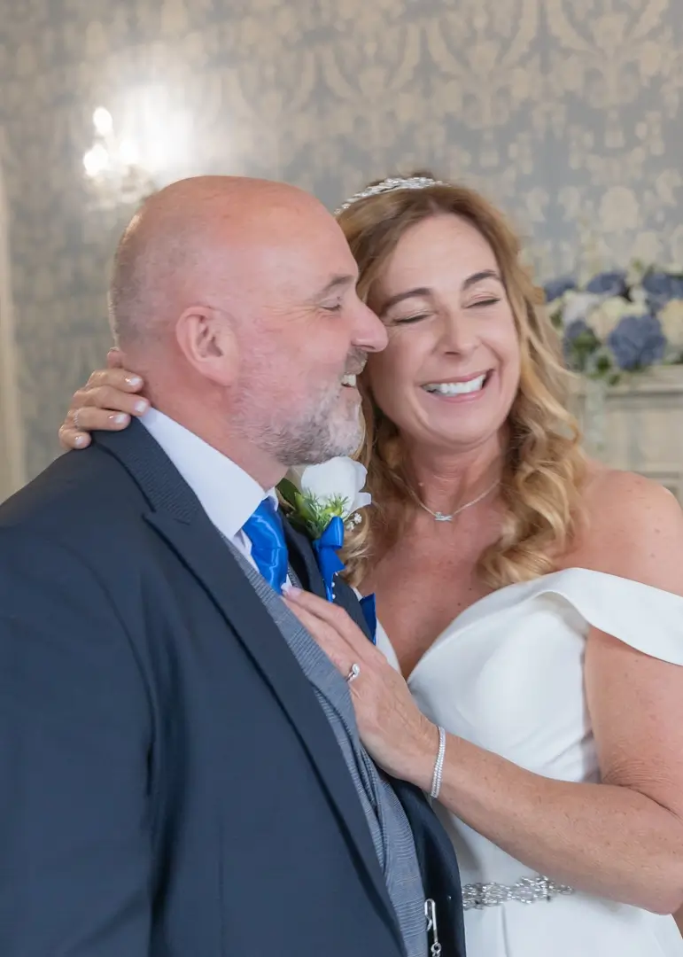 Bride and groom giggling during their wedding ceremony at Langtons House