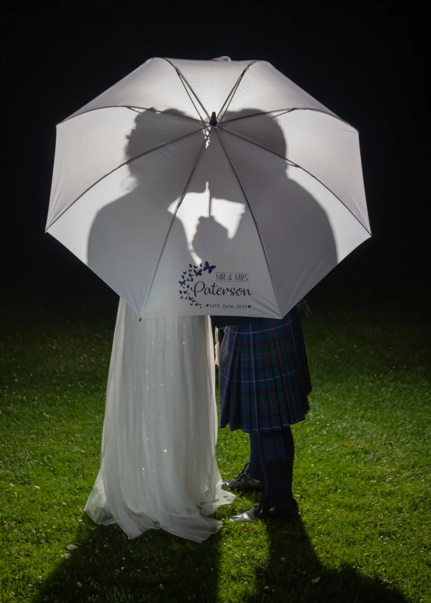 night time umbrella silhouette photo at The Fennes
