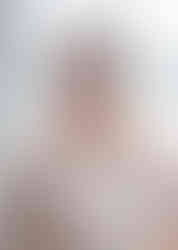 Gosfield church wedding photo of smiling bide with a pastel bouquet