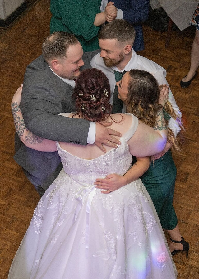 Bride and groom dancing with wedding guests shot from above