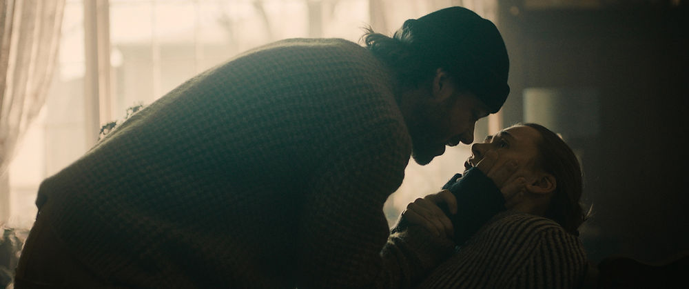 Man leaning over woman in a dramatic tv series movie scene