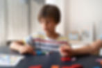 front-view-kid-making-puzzle-table.jpg