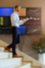 successful-smart-caucasian-businessman-walking-stair-trade-stock-with-smartphone-communica