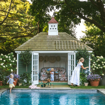 Image of 'The Alison' shed, a versatile structure with a stylish hipped roof and French doors. Designed for multiple uses including as a pool house, home office, garden house, and potting shed. The shed is depicted in a serene garden setting, highlighting its practicality and aesthetic appeal