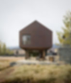 Copper-clad modern ranch house in Driggs Idaho, with upper level cantilevered over concrete patio below. The project includes four bedrooms, three and a half bathrooms, a great room, covered outdoor patio, mudroom and laundry, foyer, and three-car garage. In addition, there is a guest apartment above the garage with a discrete entry. Custom home designed by Ho & Lacy.