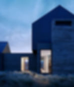 Sunset silhouette of modern ranch home tucked into the Teton Valley. Custom home in Driggs Idaho designed by Ho & Lacy Architects.