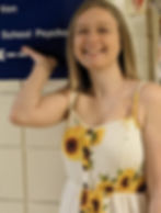 Audrey in front of school of psychology sign.