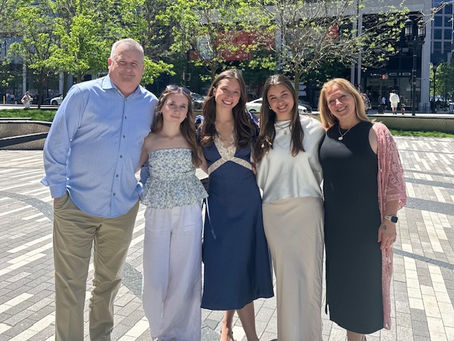Mike and his family dressed up on a beautiful sunny day