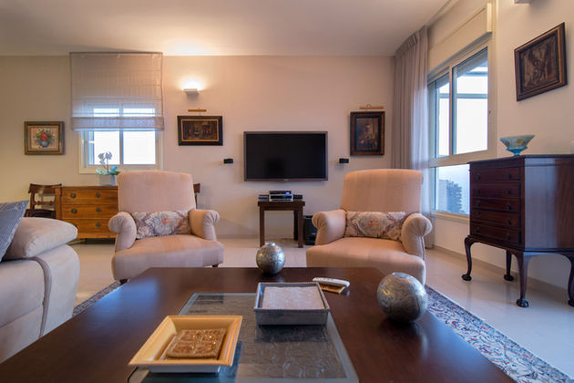 An apartment in Natanya that combines old and new style. Furniture of the antique-style landlady in a new apartment creates an eclectic elegant and bright apartment.