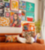 Curated gallery wall with framed prints in mismatched warm-toned frames — design direction and virtual styling by Oddité Interiors