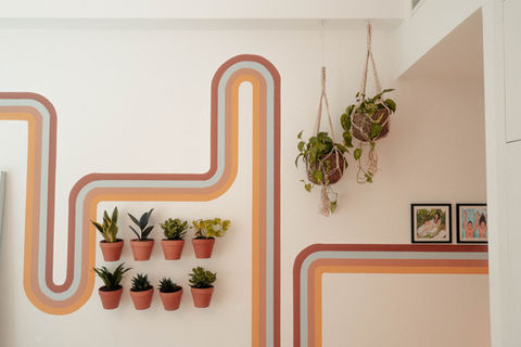 Cover image: bedroom with hand-painted retro 70s mural in terracotta and ochre, vintage upcycled dresser with Mediterranean t