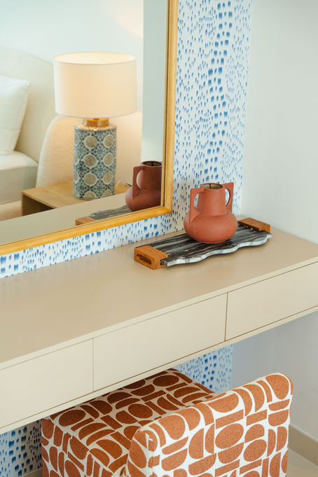 Balcony evening view with brass lantern, linen cushion, and sand-tone outdoor side table