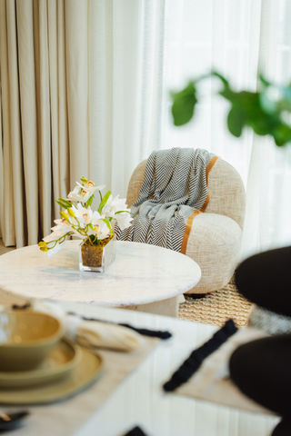 Cover image: living room with ink-toned accent wall, ivory bouclé sofa, oak coffee table, and brass arc floor lamp