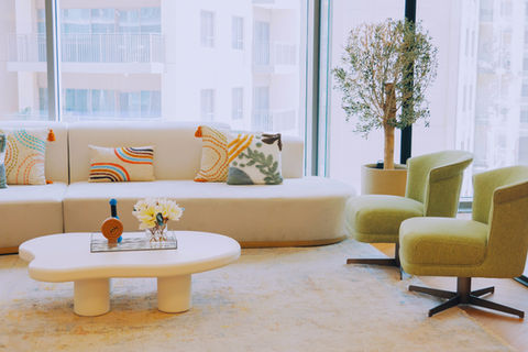 Cover image: open-plan workspace with walnut desking, plaster wall, brushed brass pendant lighting at Nexus Holiday Homes office Dubai