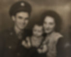 World War II solider with his wife and young daughter, early-1940s.