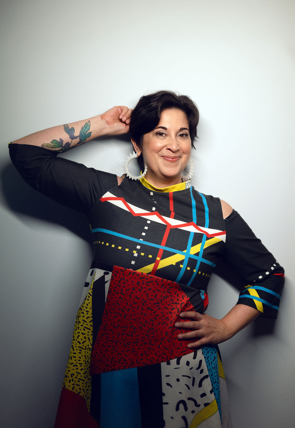 Kamala smiles at the camera in a bright, patterned top.