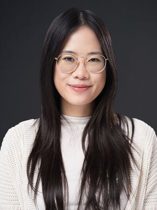 Graduating student wearing glasses posing for a professional headshot