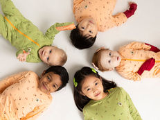 Children wearing natural-fibre clothing suitable for eczema-prone skin