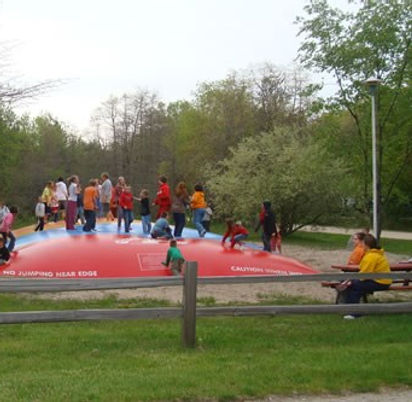 Group of people bouncing on Bounce Pillow at Muskegon Campground