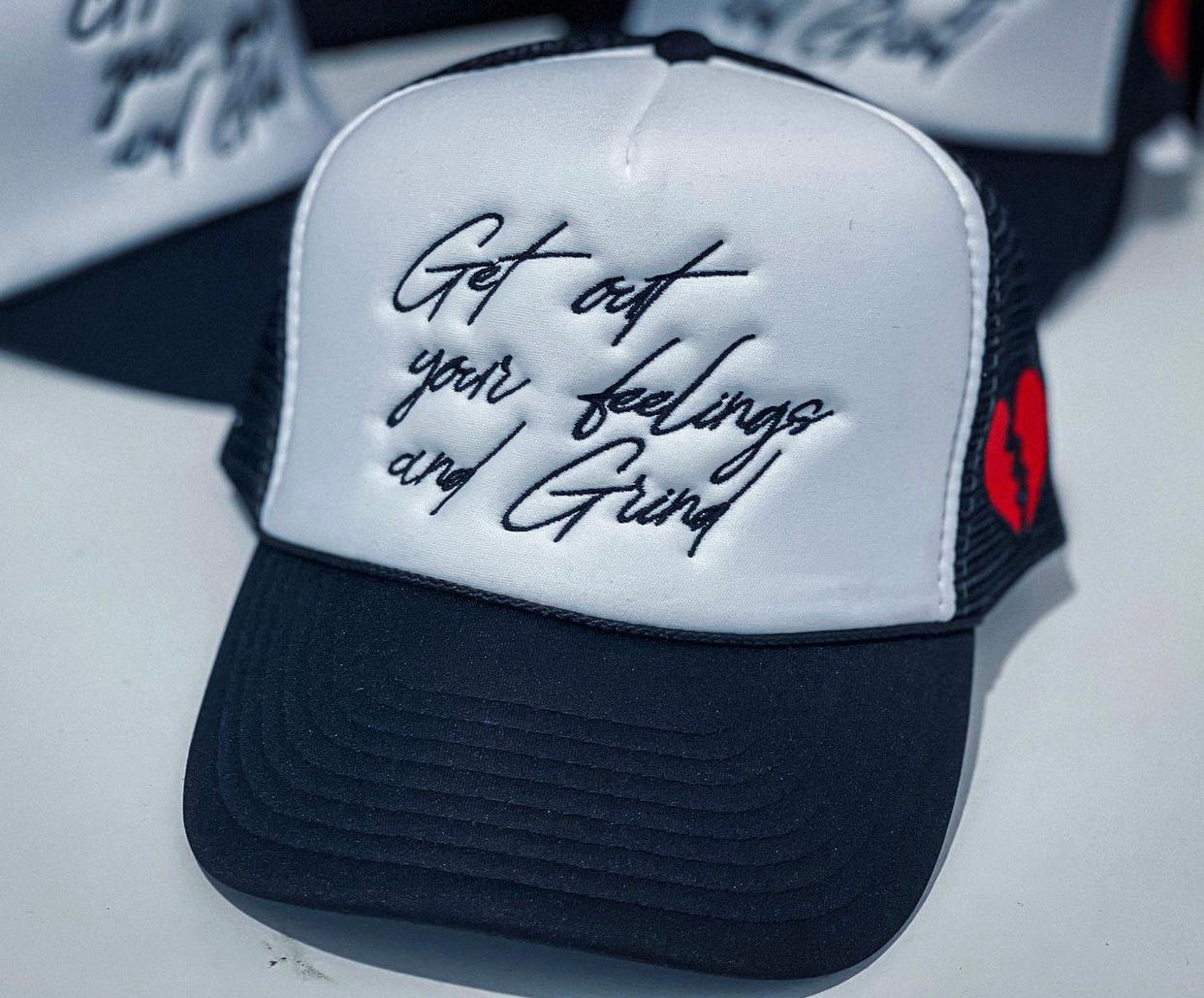 Emotions “Get Out Your Feelings and Grind” trucker hats