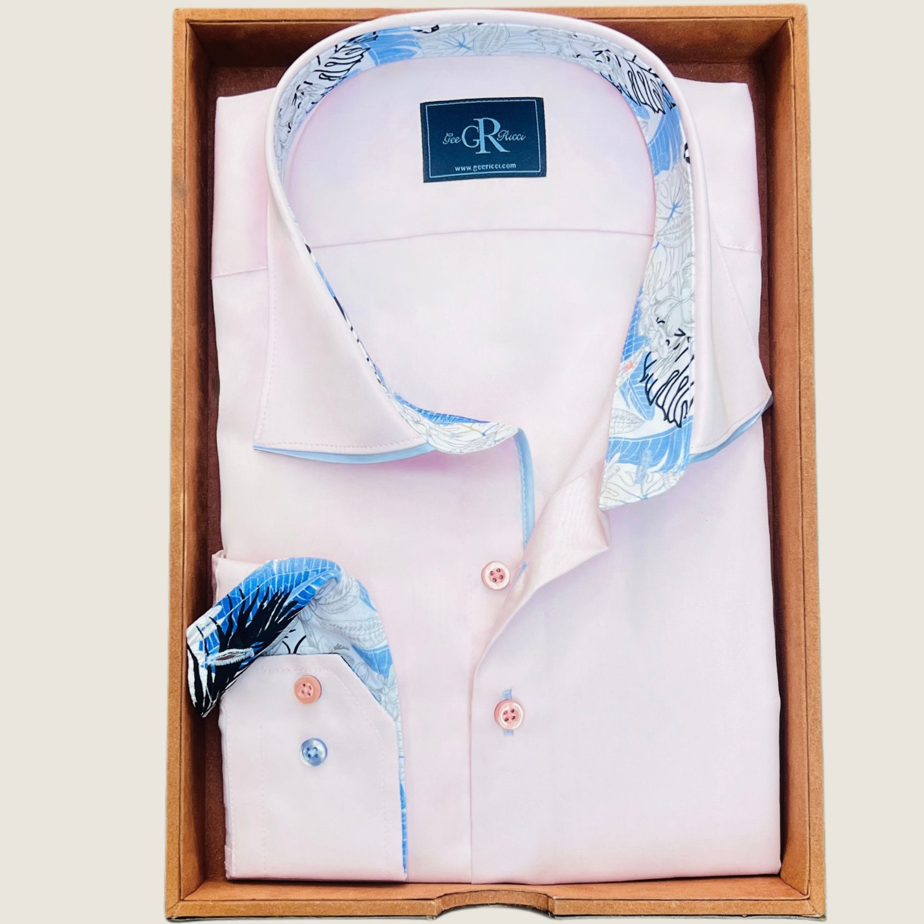a pink shirt with light blue collar trim