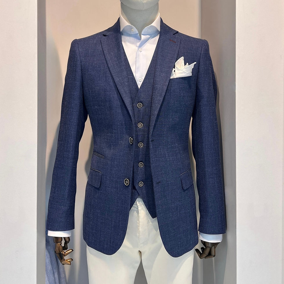 A blue linen look blazer and matching waistcoat paired with off white chinos