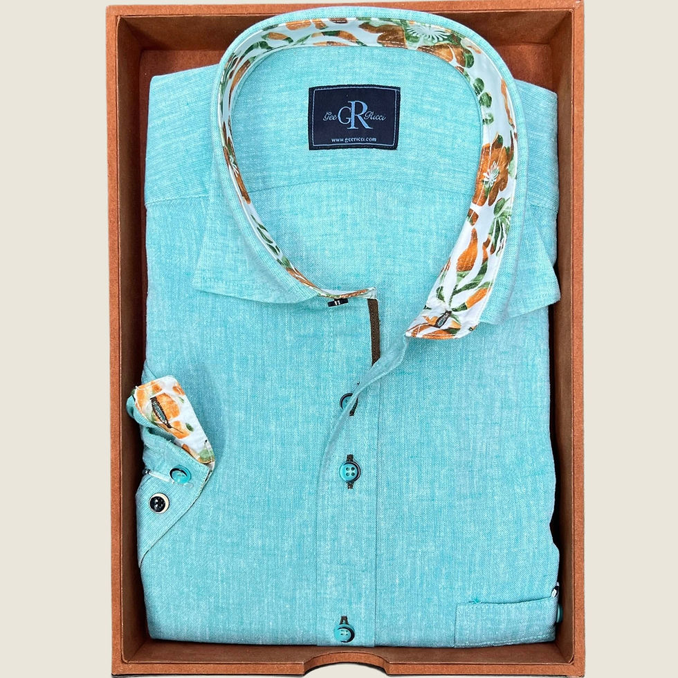 Turquoise Gee Ricci shirt with floral trim, neatly folded in a gift box.
