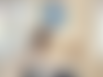 Smiling female pediatrician at Swiss Medical Services in Prague holding a toy for a toddler during a winter check-up