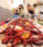 two girls eat austin texas crawfish boil with ragin tails seafood co