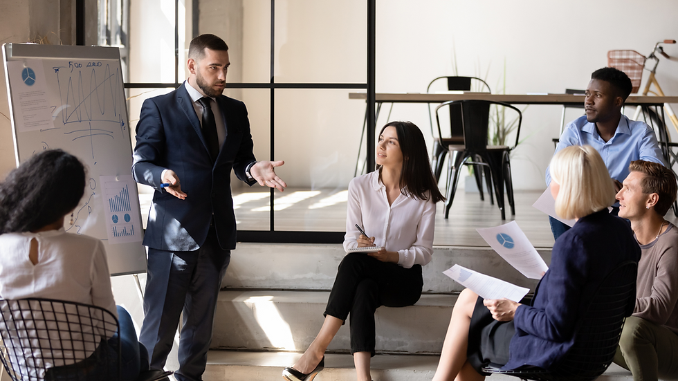 Sales coach providing personalized coaching to a group of professionals, focusing on strategies for building relationships and achieving business growth.