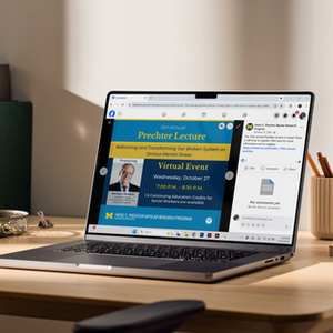 Laptop displaying a virtual lecture event announcement.