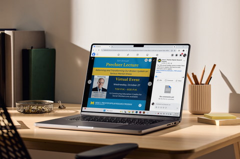 Laptop displaying a virtual lecture event announcement.