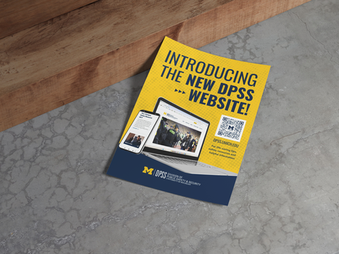 Flyer announcing new DPSS website on a table.