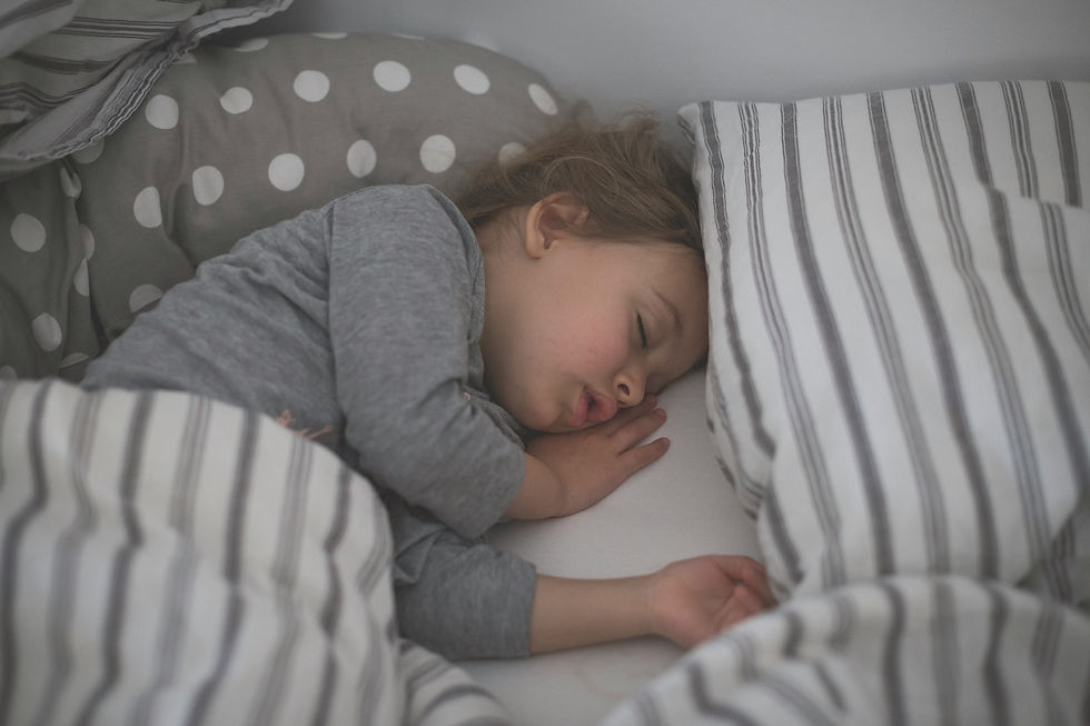 child sleeping on bed in grey pyjamas can hypnotherapy help my child sleep