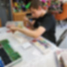 Austin strings beads in the Conway HDC art room.