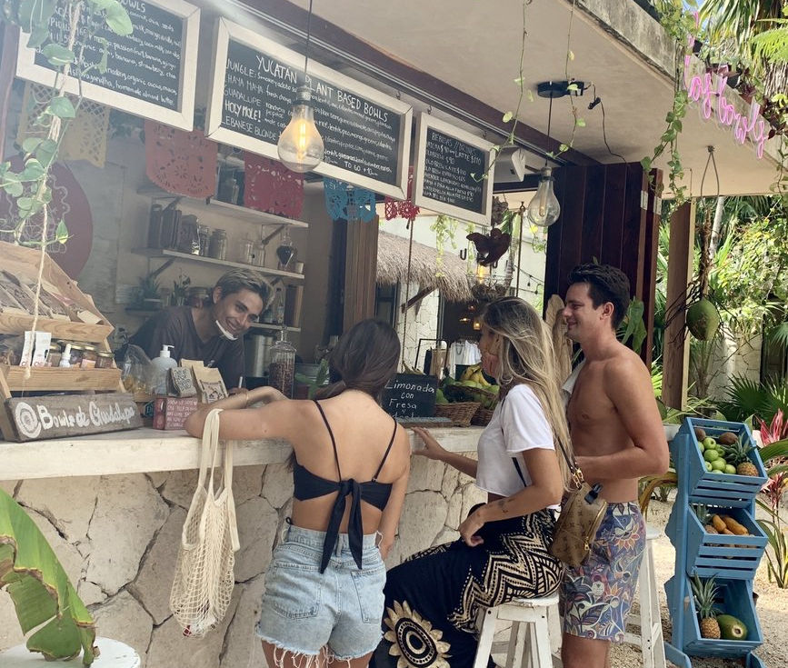 Staff member holding fresh watermelon juice Los Bowls de Guadalupe Tulum brand experience