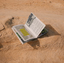 Brand print collateral photographed on the beach, art direction