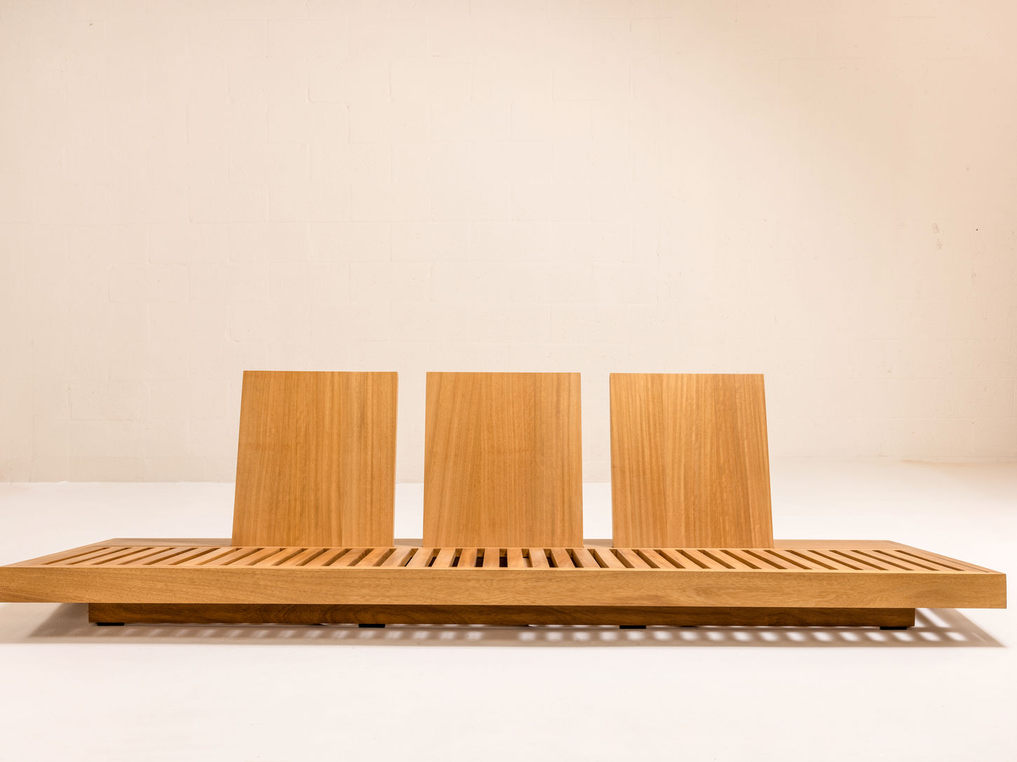 ARÉ Collection by Cristina Recio crafted from solid Iroko wood, featuring minimalist outdoor furniture with clean lines, natural materials, and architectural form.