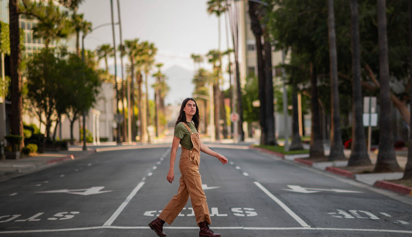 High School Senior walking across the street
