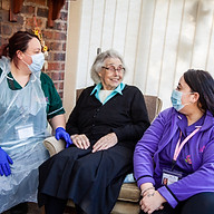 Two carers and elderly person