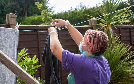 carer hanging up washing