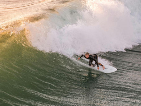 A man surfing on the beach.