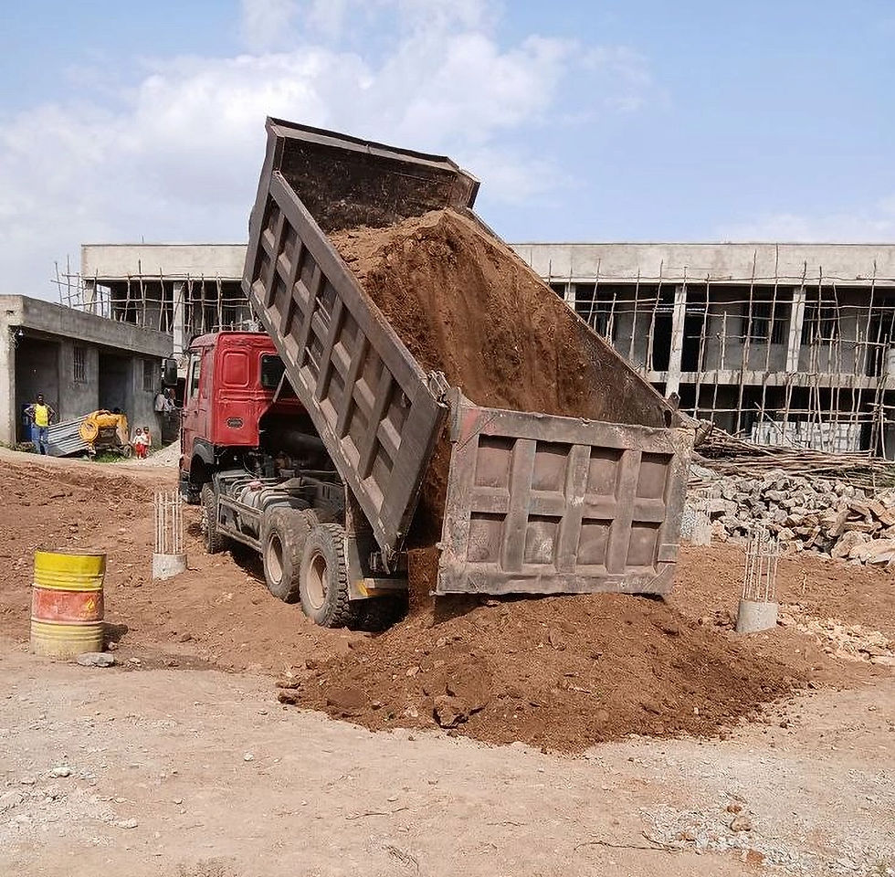 Dump truck unloading soil for construction materials supply