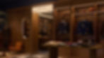 Store interior with wooden walls, shelves displaying jackets, folded clothes, and sports items. A sign reads "Sound Club." Cozy atmosphere.