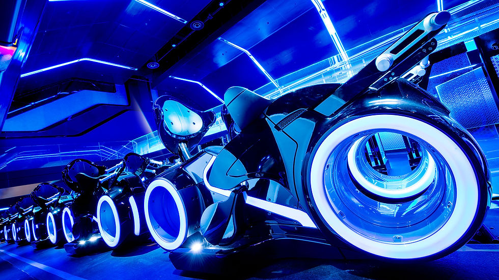 Futuristic bikes with glowing blue wheel rims in a neon-lit room. Sleek design and vibrant colors create a high-tech, dynamic ambiance.