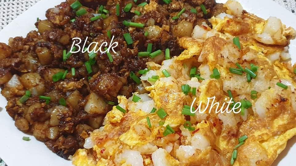 Two plates of fried radish cake labeled "Black" and "White," garnished with green onions, on a white plate.